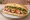 Bánh Mì Mềm: an illustration of pork, pâté, mayonnaise, đồ chua and more on bánh mì baguette.