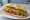 Bánh Mì Mì Căn Xào: an illustration of mock meat, đồ chua, cucumber and cilantro on bánh mì baguette.