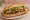 Bánh Mì Nấm Xào: an illustration of mushroom, đồ chua, cucumber and cilantro on bánh mì baguette.