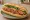Bánh Mì Nem Chua Rán: an illustration of pork, đồ chua, cucumber and cilantro on bánh mì baguette.