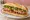 Bánh Mì Nem Nướng Nha Trang: an illustration of pork, đồ chua, cucumber, cilantro and more on bánh mì baguette.
