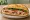 Bánh Mì Như Lan: an illustration of pork, pâté, đồ chua, cucumber and more on bánh mì baguette.