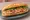 Bánh Mì Nóng Giòn: an illustration of pork, pâté, đồ chua, cucumber and more on bánh mì baguette.