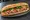 Bánh Mì Ổ Lớn: an illustration of pork, pâté, đồ chua, cucumber and more on bánh mì baguette.