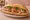 Bánh Mì Ổ Saigon: an illustration of pork, pâté, đồ chua, cucumber and more on bánh mì baguette.