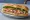 Bánh Mì Paris: an illustration of pork, pâté, đồ chua, cucumber and more on baguette.