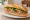 Bánh Mì Pâté Gan: an illustration of pork, pâté, đồ chua, cucumber and more on bánh mì baguette.