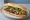 Bánh Mì Phá Lấu: an illustration of pork, five-spice, maggi seasoning sauce, đồ chua and more on bánh mì baguette.