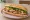 Bánh Mì Phượng Saigon: an illustration of pork, pâté, đồ chua, cucumber and more on bánh mì baguette.