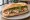 Bánh Mì Praha: an illustration of pork, pâté, đồ chua, cucumber and more on bánh mì baguette.