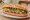 Bánh Mì Quán: an illustration of pork, pâté, đồ chua, cucumber and more on bánh mì baguette.