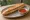 Bánh Mì Que Pate: an illustration of pâté and sriracha on bánh mì baguette.