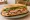 Bánh Mì Sài Gòn Đặc Biệt: an illustration of pork, chả lụa, pâté, đồ chua and more on bánh mì baguette.