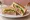 Bánh Mì Sandwich: an illustration of pork, pâté, mayonnaise, đồ chua and more on white bread.