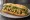 Bánh Mì Sò: an illustration of shellfish, đồ chua, cucumber and cilantro on bánh mì baguette.