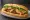 Bánh Mì Thịt Kho Tàu: an illustration of pork, caramel sauce, đồ chua, cucumber and more on bánh mì baguette.