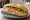 Bánh Mì Thịt Luộc: an illustration of pork, đồ chua, cucumber and cilantro on bánh mì baguette.
