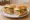 Bánh Mì Tiệc: an illustration of pâté, mayonnaise, đồ chua, cucumber and more on bánh mì baguette.