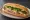 Bánh Mì Trâm: an illustration of pâté, mayonnaise, đồ chua, cucumber and more on bánh mì baguette.