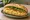 Bánh Mì Trứng Bác: an illustration of egg, đồ chua, cucumber and cilantro on bánh mì baguette.