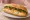Bánh Mì Trứng Luộc: an illustration of egg, đồ chua, cucumber and cilantro on bánh mì baguette.