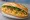 Bánh Mì Trứng Muối: an illustration of egg, đồ chua, cucumber and cilantro on bánh mì baguette.