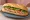 Bánh Mì Vỉa Hè: an illustration of pâté, đồ chua, cucumber and cilantro on bánh mì baguette.