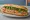 Bánh Mì Việt Kiều: an illustration of pâté, đồ chua, cucumber and cilantro on bánh mì baguette.