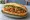 Bánh Mì Xíu Mại Chay: an illustration of tomato, ketchup, đồ chua, cucumber and more on bánh mì baguette.