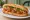 Bánh Mì Xíu Mại: an illustration of pork, tomato, ketchup, đồ chua and more on bánh mì baguette.