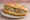 Bánh Mì Xôi Khúc: an illustration of pork and rice on bánh mì baguette.