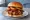 BBQ Bacon Burger: an illustration of beef, bacon, onion and bbq sauce on burger bun.