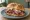 Beef on Weck with Horseradish: an illustration of beef and horseradish on kaiser roll.