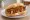 Bio Currywurst: an illustration of curry powder on kaiser roll.