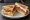 BLT (British): an illustration of bacon, lettuce, tomato and mayonnaise on white bread.