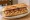 Bocadillo de Butifarra con Mongetes: an illustration of beans and pork on baguette.
