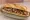 Bocadillo de Churrasco: an illustration of pork, garlic, olive oil and parsley on baguette.