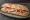 Bocadillo de Lacón: an illustration of pork, paprika and olive oil on baguette.