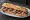 Bocadillo de Longaniza de Aragón: an illustration of pork, garlic and pepper on baguette.