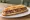 Bocadillo de Longaniza Valenciana: an illustration of pork, garlic and pepper on baguette.
