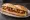 Bocadillo de Pastel de Carne: an illustration of beef, chorizo, egg and onion on baguette.