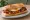 Bocadillo de Pisto Manchego: an illustration of egg, tomato, pepper, onion and more on baguette.