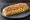 Bocadillo de Pollo al Curry: an illustration of chicken, curry powder, mayonnaise and onion on baguette.