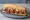 Bocadillo de Pulled Pork: an illustration of pork and coleslaw on baguette.