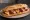 Bocadillo de Pulpo: an illustration of octopus and olive oil on baguette.