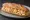 Bocadillo de Revuelto de Gambas: an illustration of shrimp, egg, garlic and olive oil on baguette.