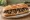 Bocadillo de Revuelto de Morcilla: an illustration of morcilla, egg, onion and olive oil on baguette.