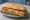 Bocadillo de San Jacobo: an illustration of pork, ham, cheese, egg and more on baguette.