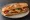Bocadillo de Solomillo: an illustration of beef, pepper, cheese and olive oil on baguette.