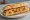 Bocadillo de Tortilla con Chorizo: an illustration of egg, potato, chorizo, onion and more on baguette.